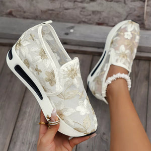 Chic floral embroidered white mesh slip-on sneakers with a chunky platform sole.