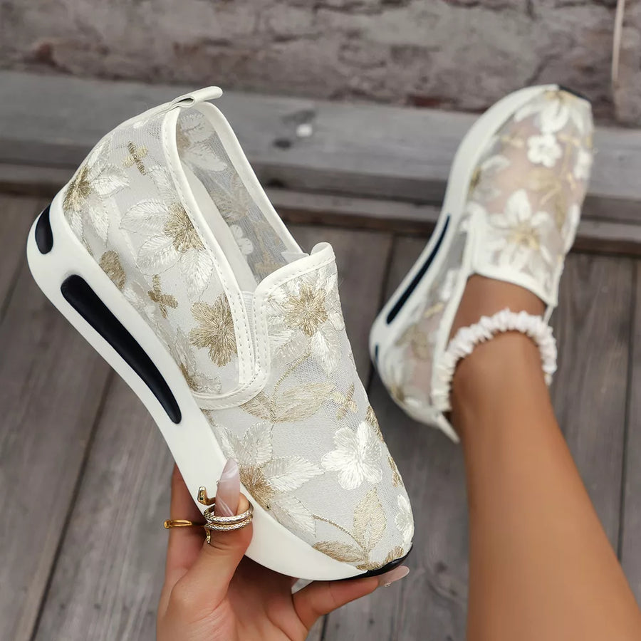 Chic floral embroidered white mesh slip-on sneakers with a chunky platform sole.