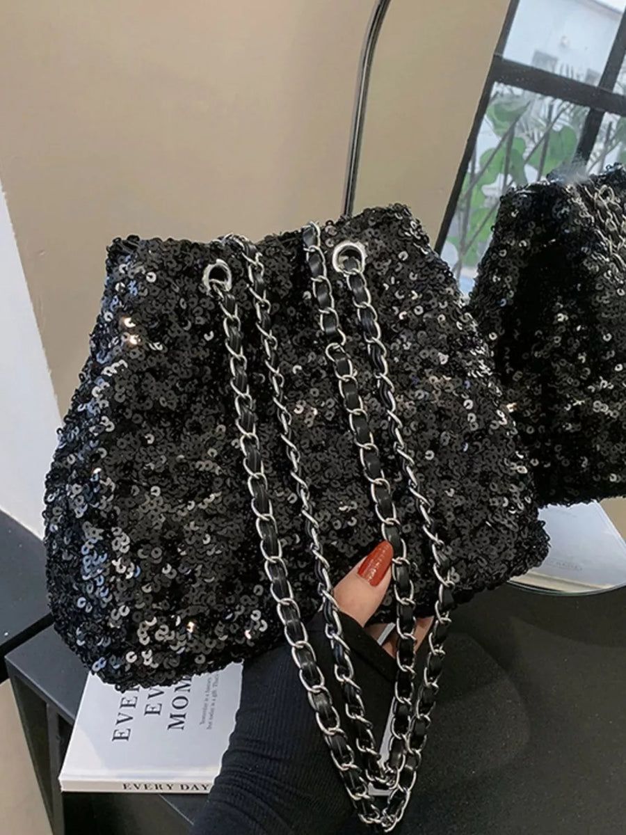 Black sequin bucket bag with silver chain strap detail