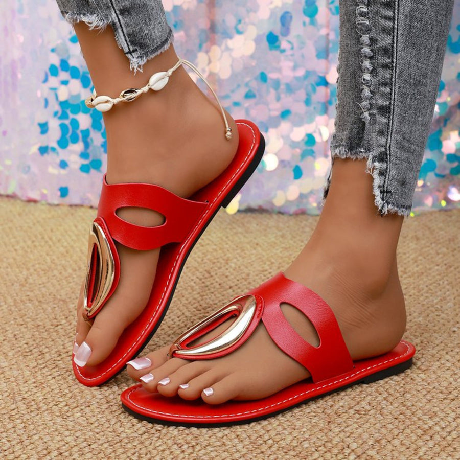 Red open-toe sandals with golden accent and contrast stitching.