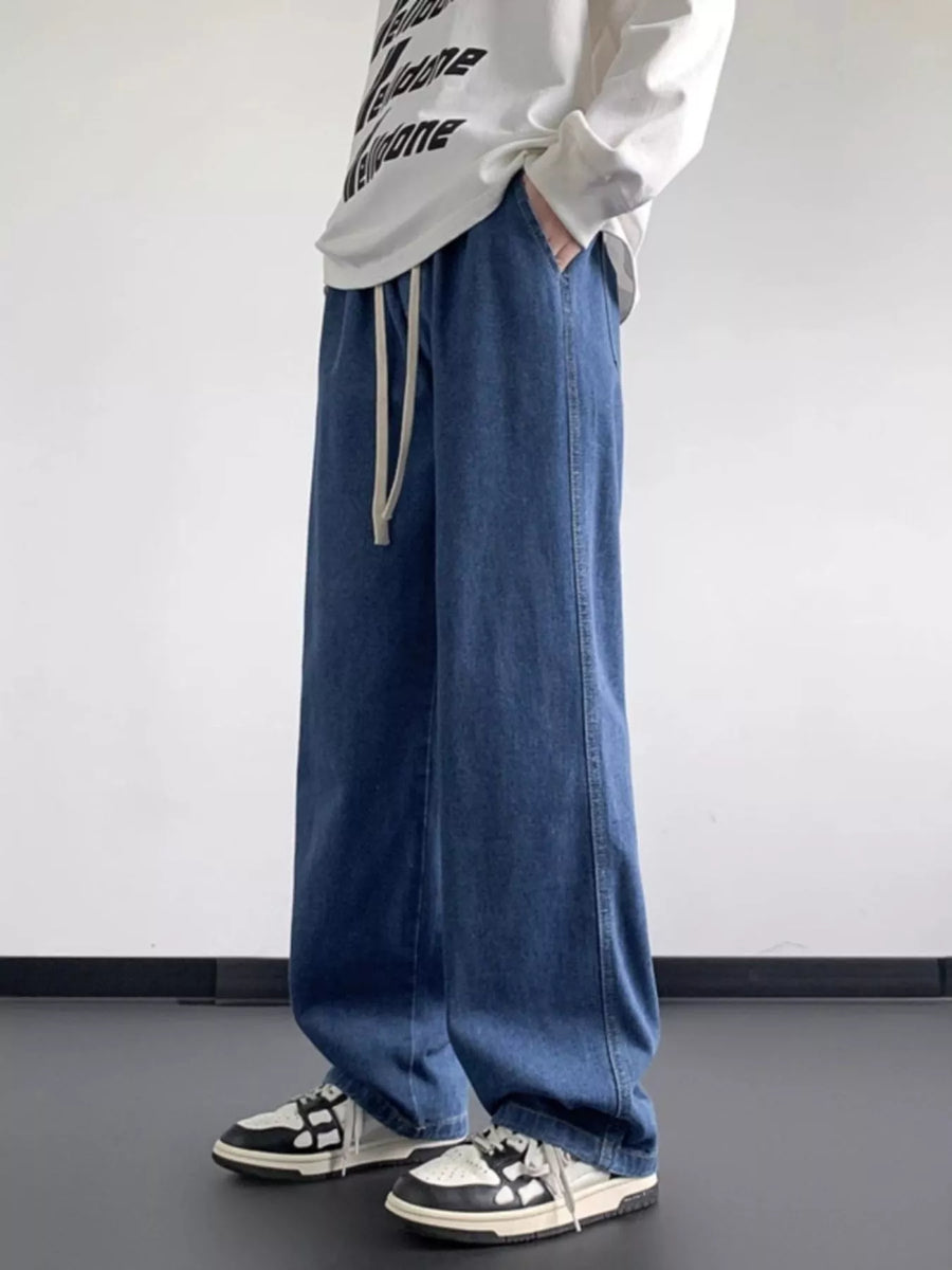 Oversized drawstring jeans in light blue denim with a loose fit and casual styling.