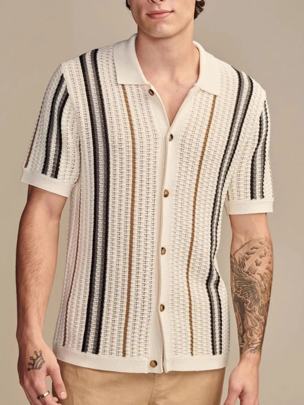 Textured stripe knit polo shirt in cream with vertical black, brown, and grey stripes.