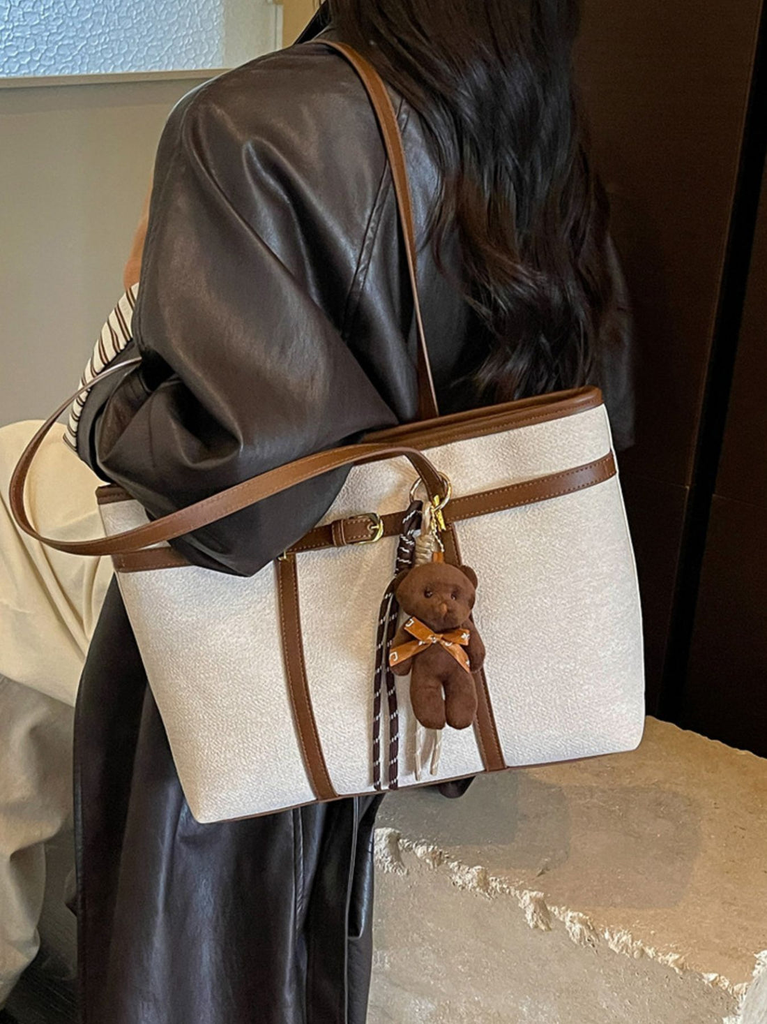 tote in cream featuring decorative buckle and boxy fit