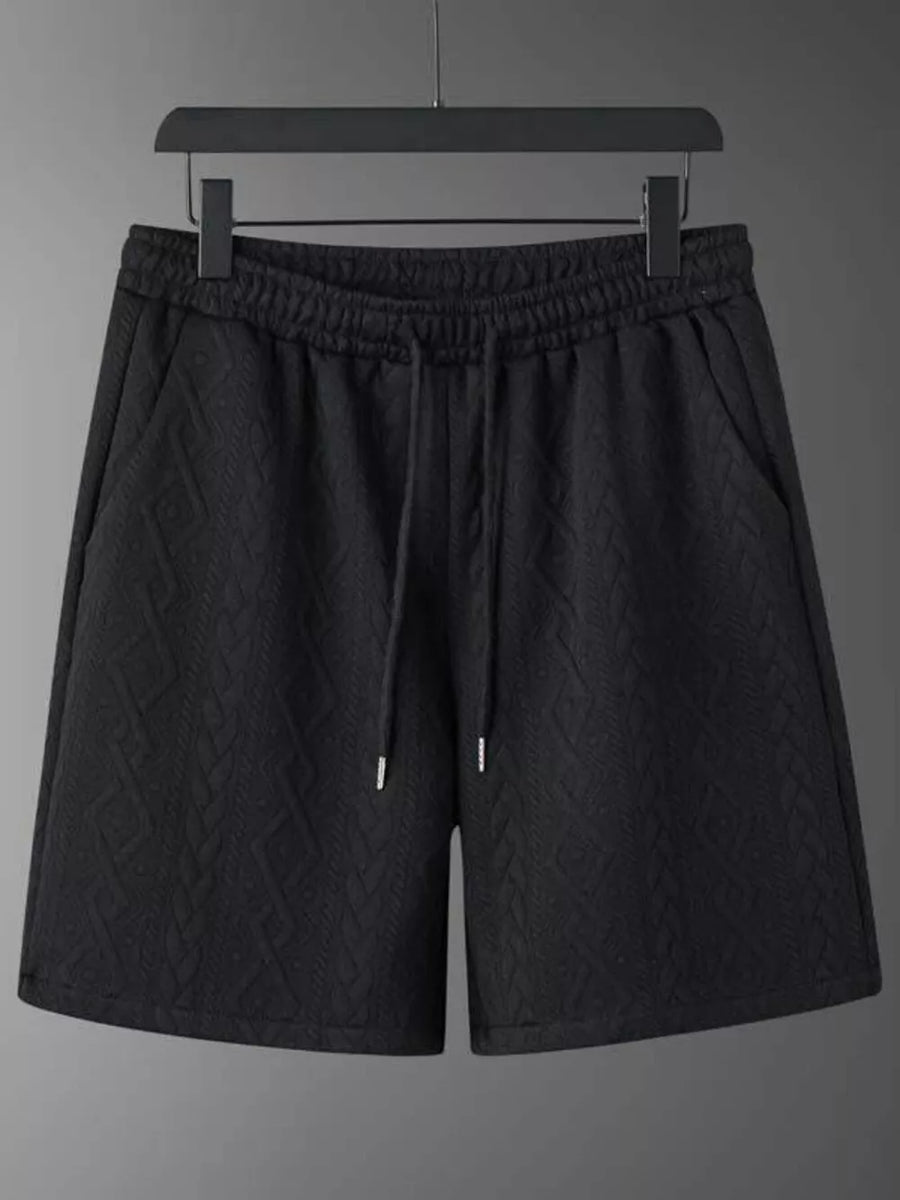 Black textured knit shorts with drawstring and pockets.