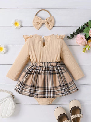 Baby girls' beige ruffled bodysuit with plaid skirt and matching bow headband.