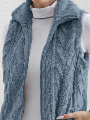 Blue faux fur zip-up vest with a textured pattern and stand-up collar.