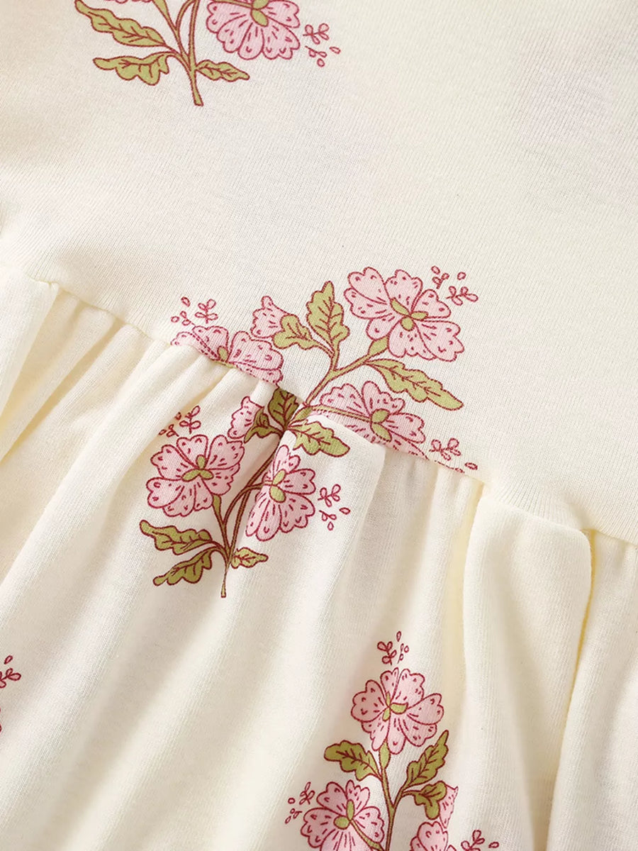 Charming floral cotton dress for toddlers in beige with pink floral print and gathered waist detail.