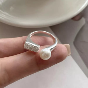 white ring featuring open design and textured
