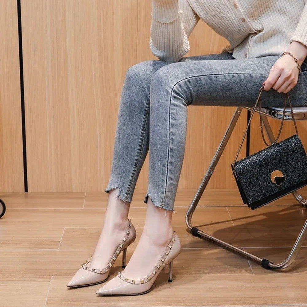 Apricot patent leather pointed-toe pumps with studded trim