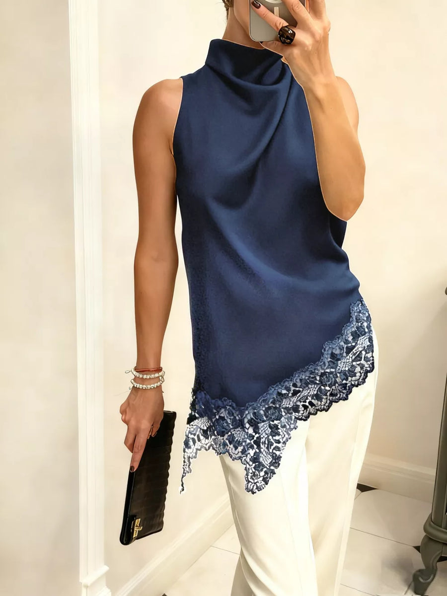 Dark blue asymmetrical cami top with lace trim and cowl neck.