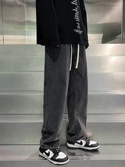 Men's gray loose-fit jeans with drawstring waist and vintage wash.
