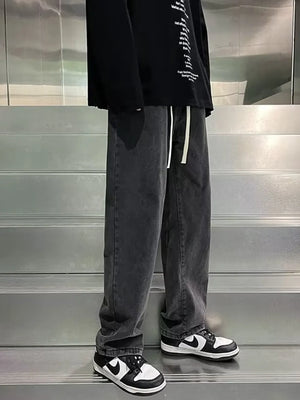 Men's gray loose-fit jeans with drawstring waist and vintage wash.