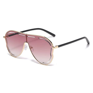 Statement aviator sunglasses with gold metal frames and gradient dusty pink lenses.