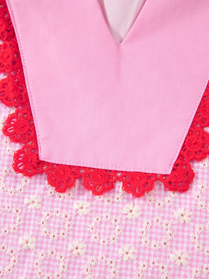 Pink gingham blouse with eyelet embroidery and red crochet trim.