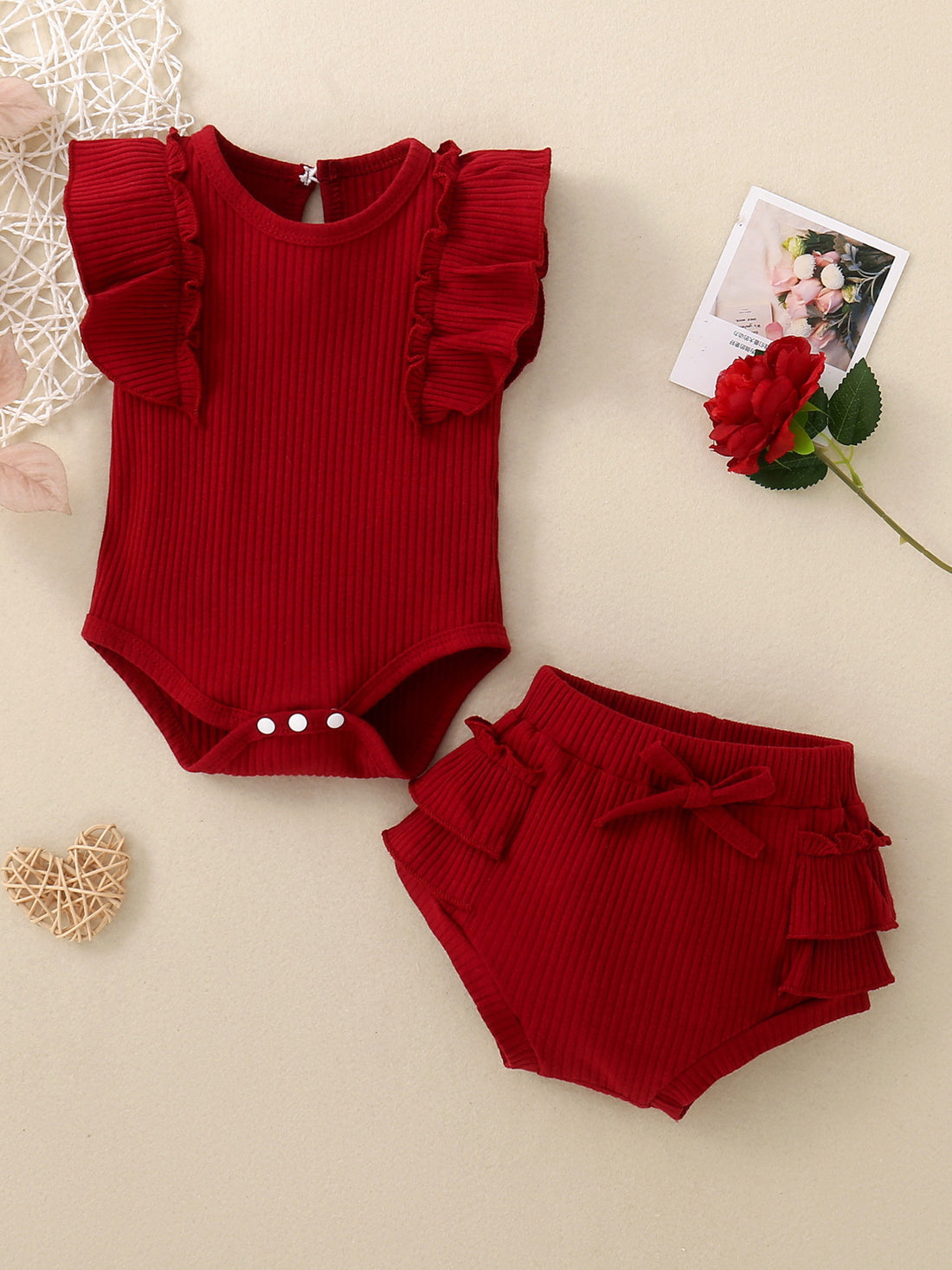 Red ribbed baby set with ruffle trim on flutter sleeves and bloomers.