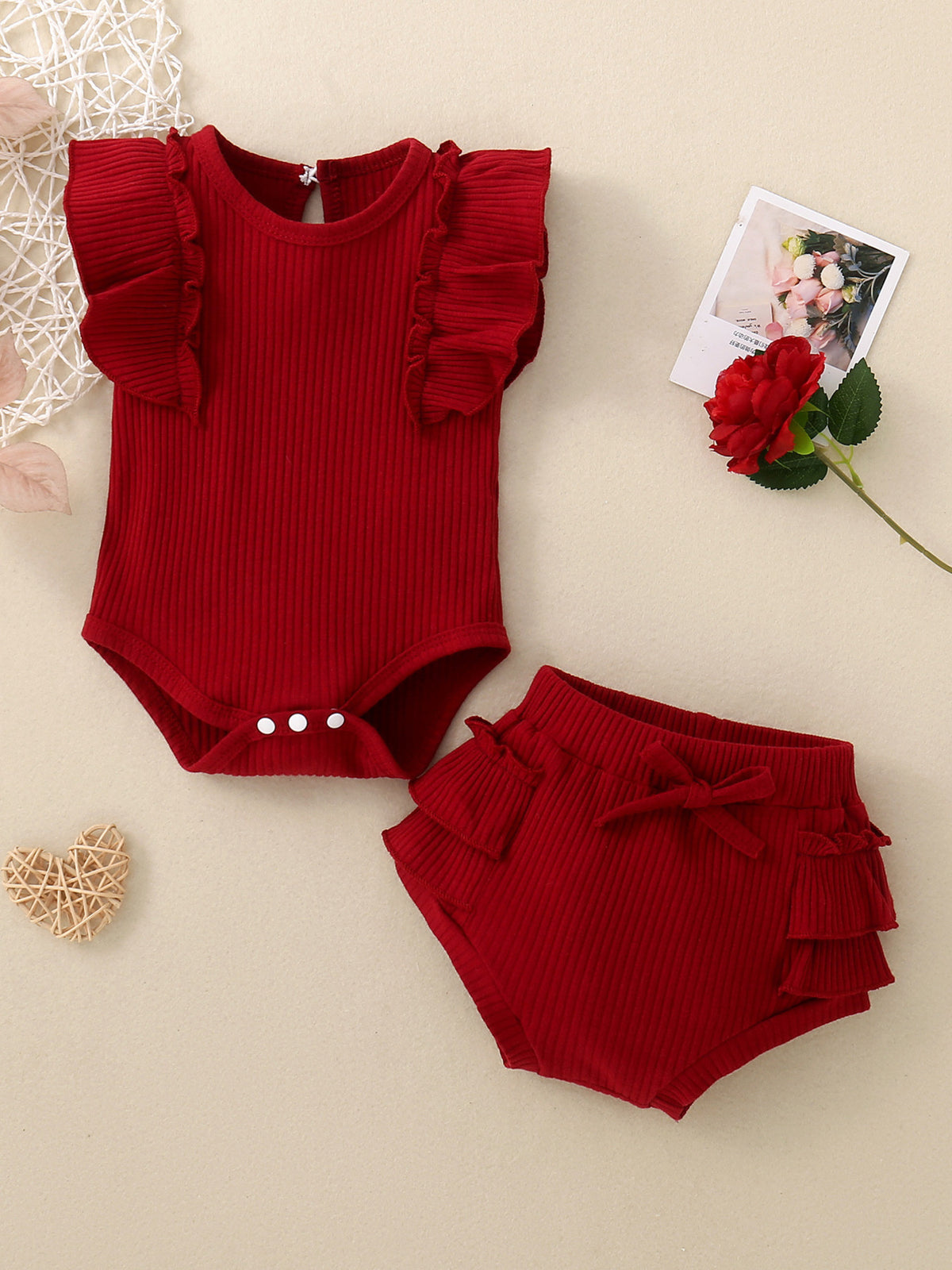 Red ribbed baby set with ruffle trim on flutter sleeves and bloomers.