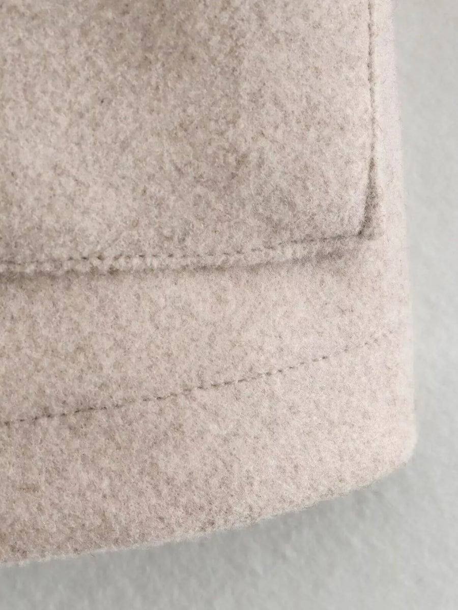 Beige trucker jacket detail showing textured fabric and stitching