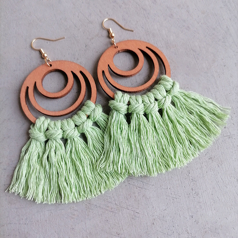 Light green tassel earrings with wooden double hoop detail