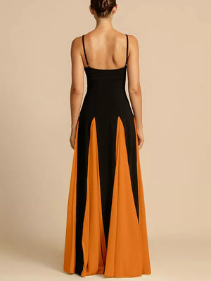 Elegant maxi dress with spaghetti straps in black and orange color blocking and a flowing skirt.