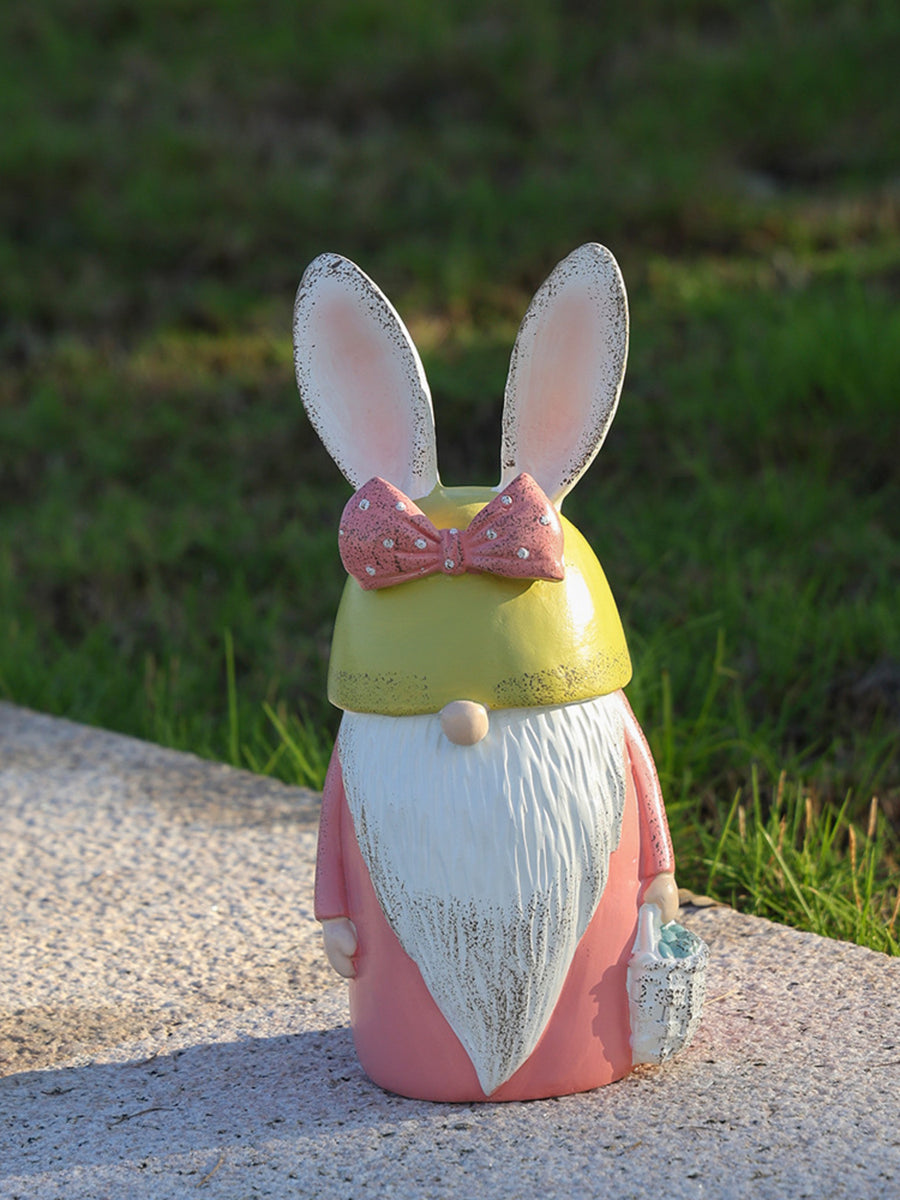 Easter bunny gnome figure in pastel blue and blush pink with a bow and basket.