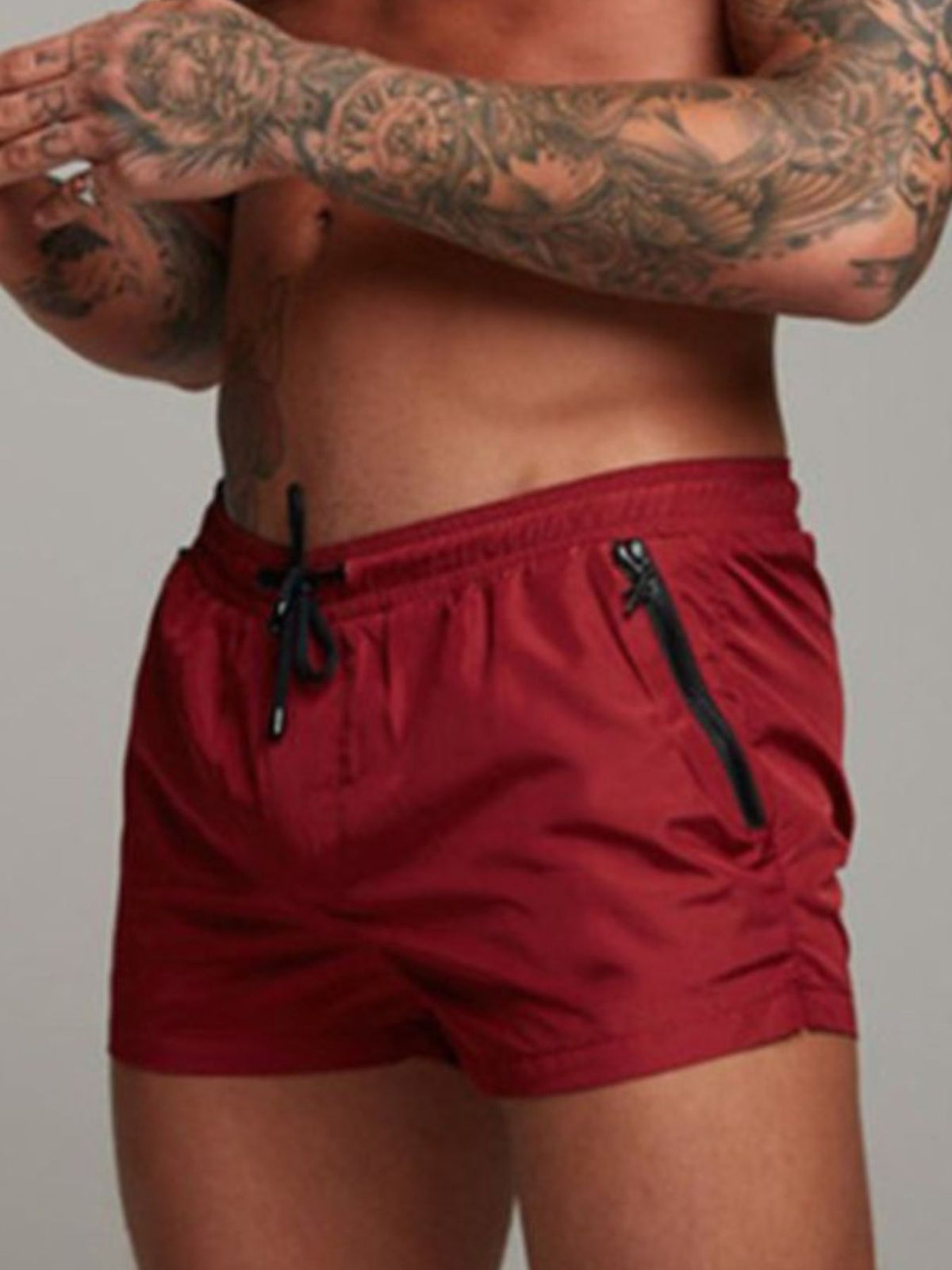 Red swim shorts with drawstring and zip pocket