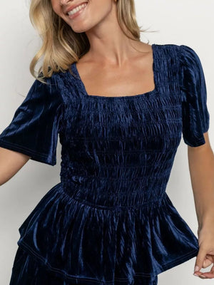 Navy blue velvet two-piece set with square neck, smocked bodice, and flutter sleeves.