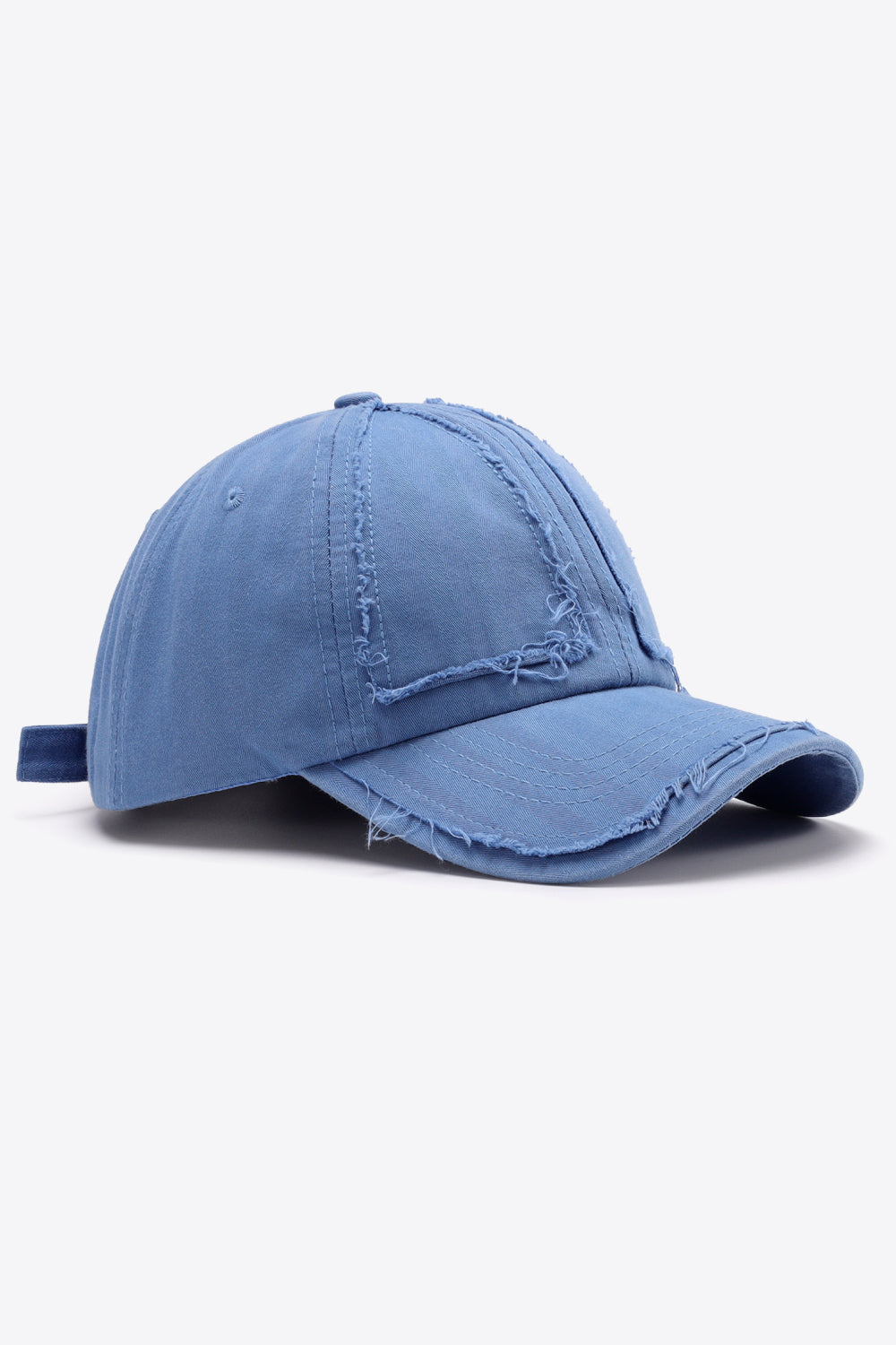 Cobalt blue denim baseball cap with raw edge details and adjustable strap.
