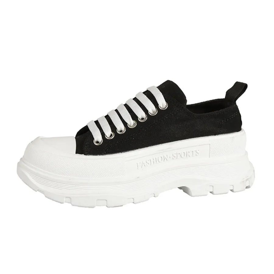 Black canvas lace-up sneakers with white laces and a chunky platform sole.