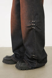Dark wash palazzo jeans with faded ombre effect and silver stud details.