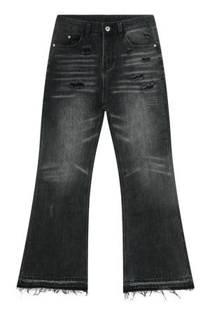 Distressed flare jeans in washed black denim with frayed hems.