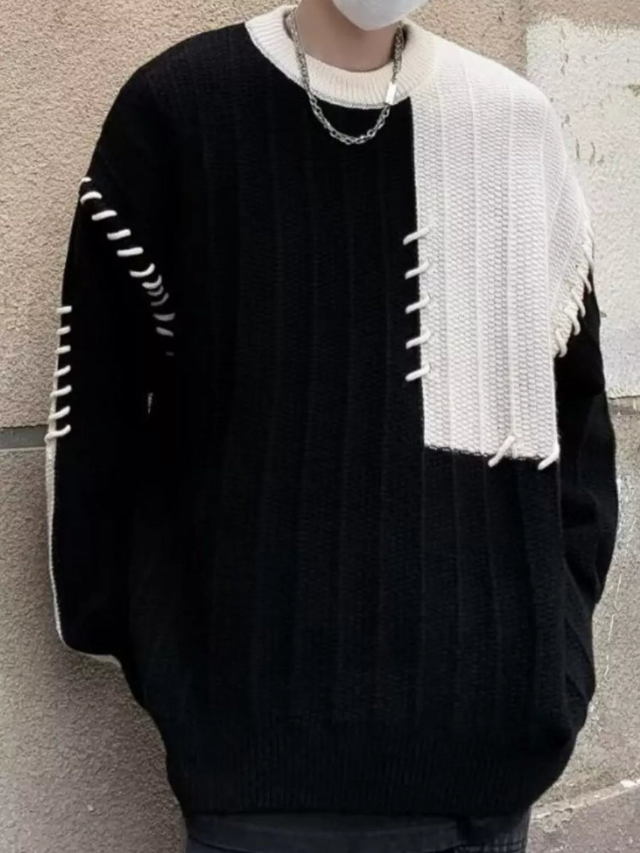 Oversized black and white color block sweater with contrast stitching detail.