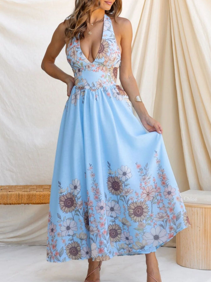 Blue floral halter neck maxi dress with a deep V-neck and flowing skirt.