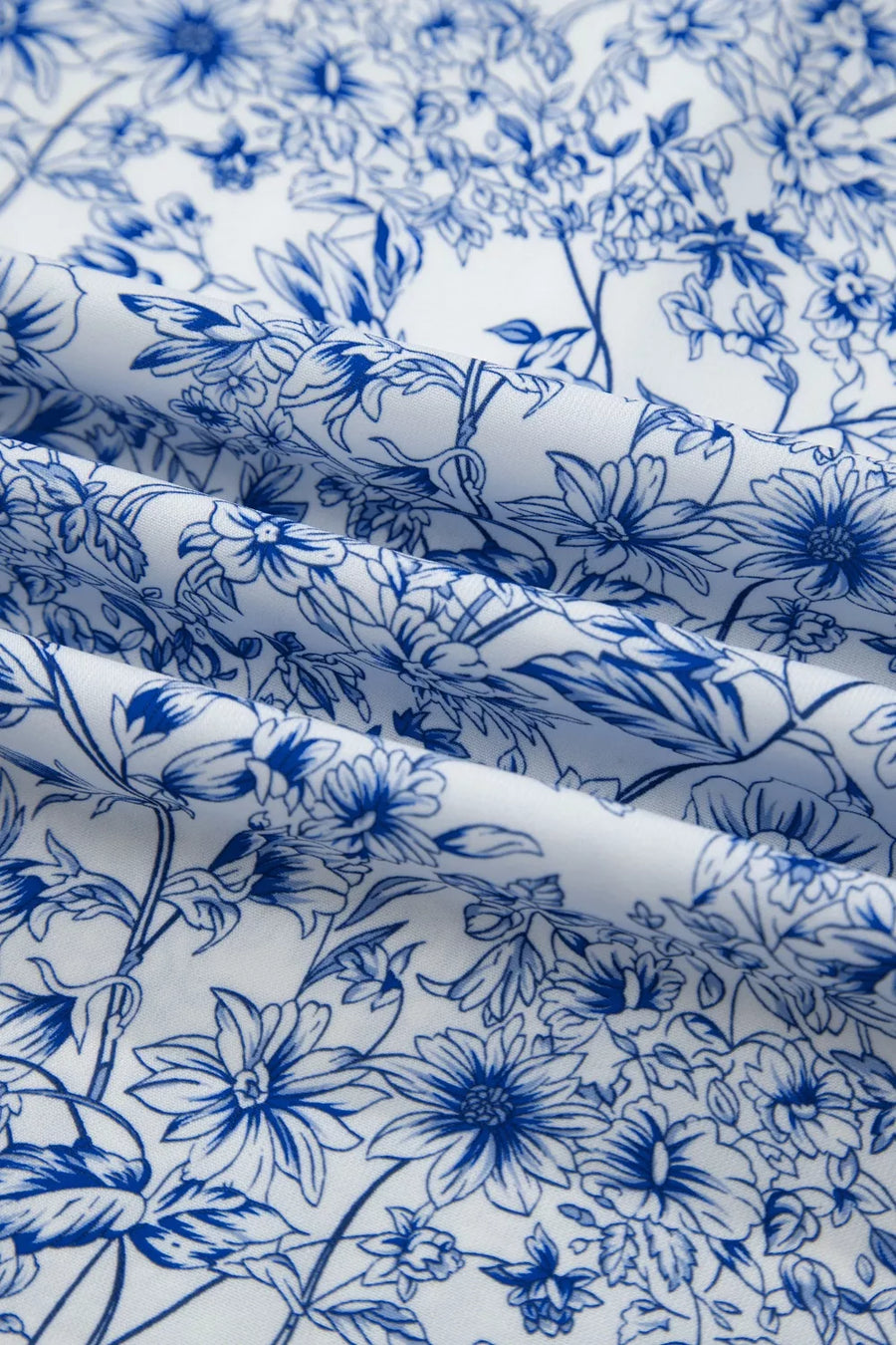 Maxi dress in white with a blue floral print and knot detail