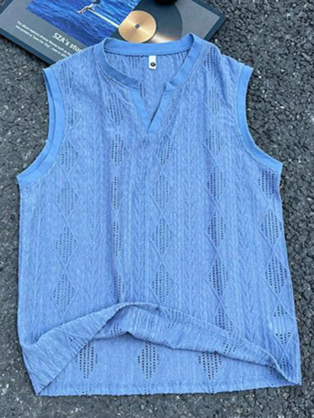 Blue textured knit tank top with relaxed V-neck and diamond pattern.