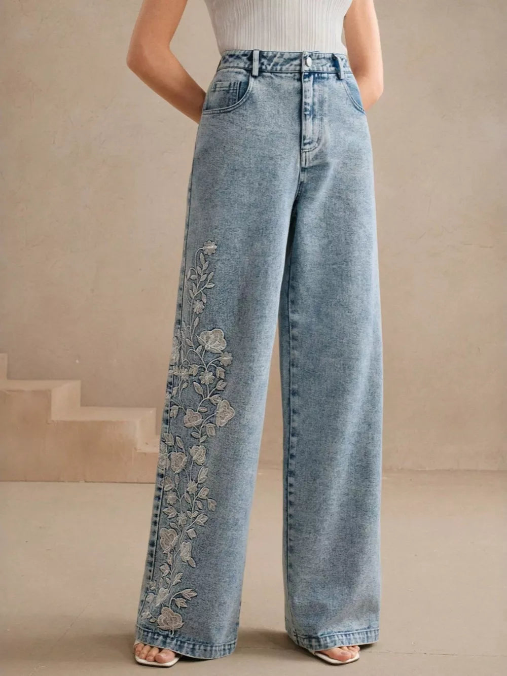 Blue wide-leg jeans featuring embroidered and floral