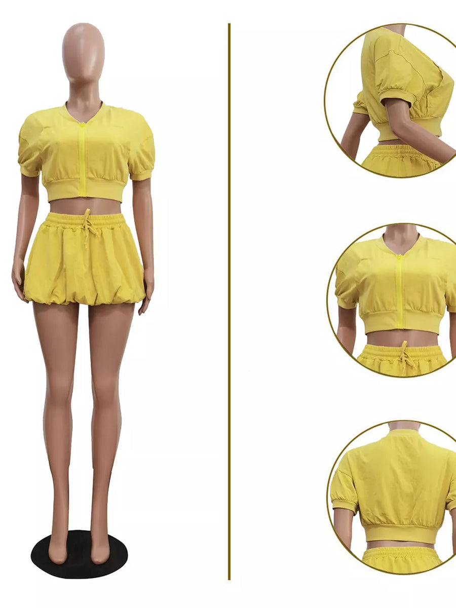 Yellow zip-up crop top with drawstring shorts set.