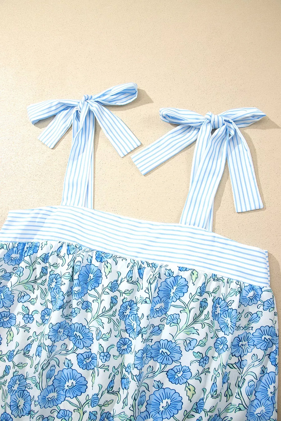 Floral print camisole top with blue striped tie straps and matching shorts set.