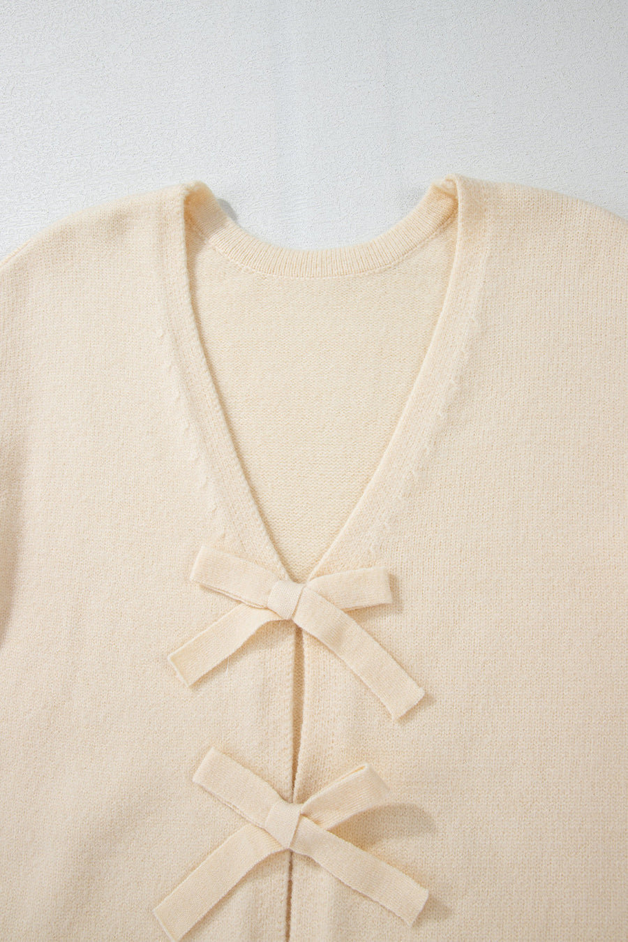 Ivory bouclé knit cardigan with tie-front bow details