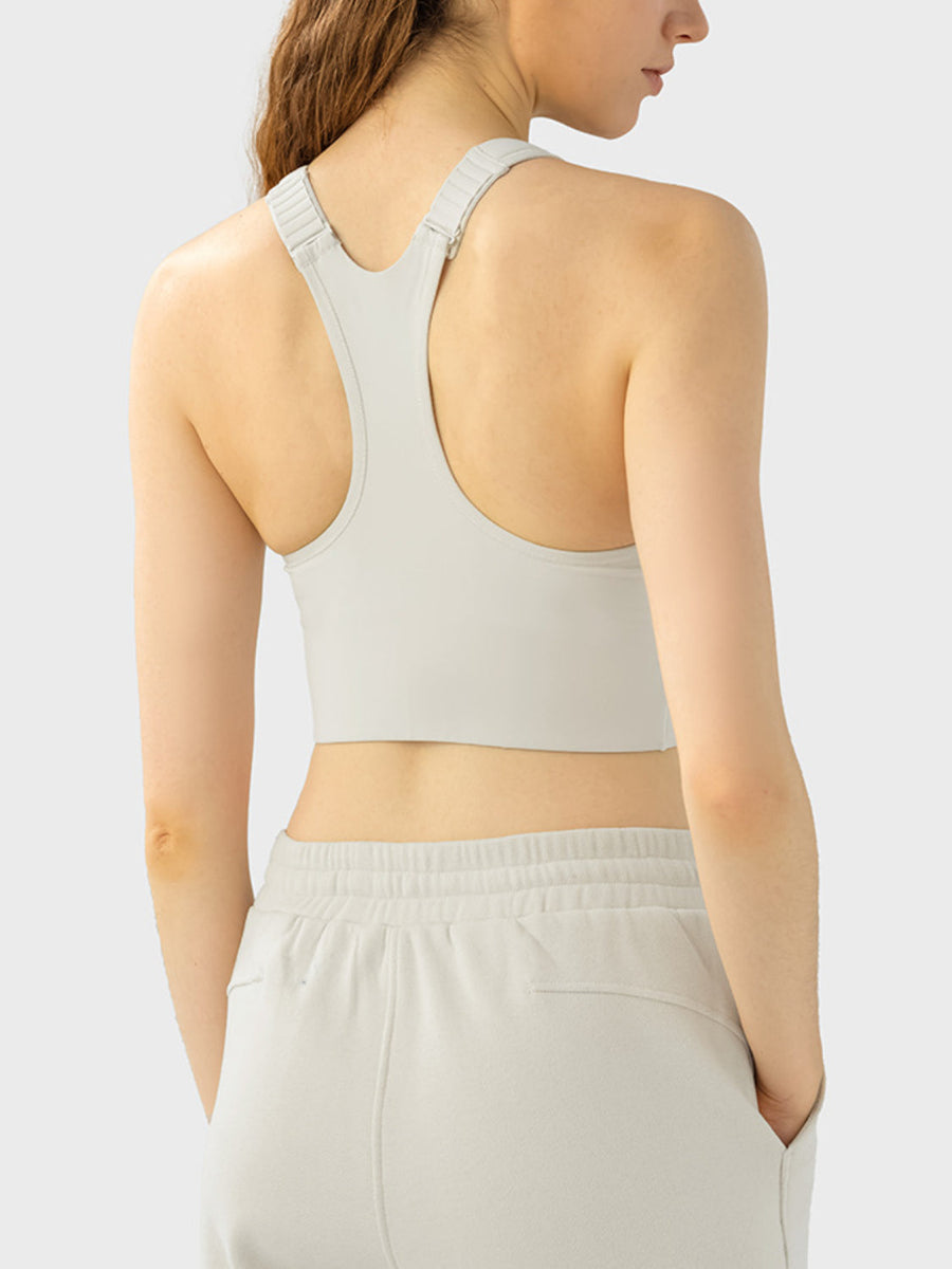 Zip-front racerback sports bra in ivory with adjustable straps.