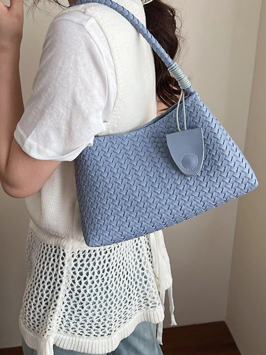 Blue woven shoulder bag with braided strap and leather tab detail