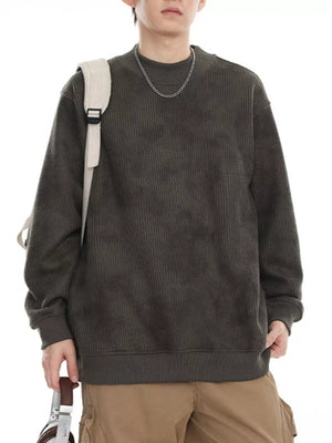 Oversized dark gray corduroy sweatshirt with a round neck and ribbed details.