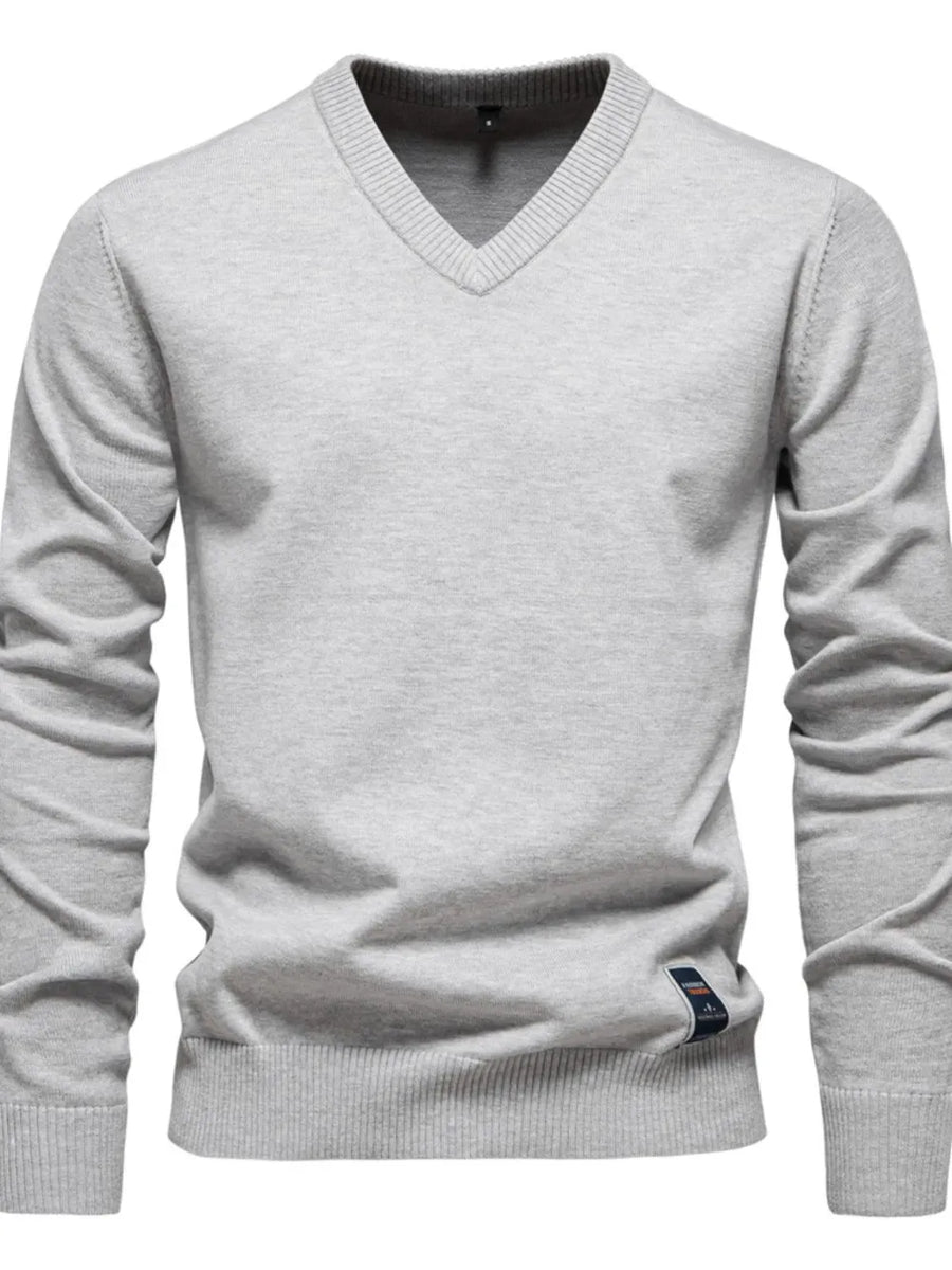 Gray ribbed knit V-neck sweater with long sleeves and a small logo tag detail.