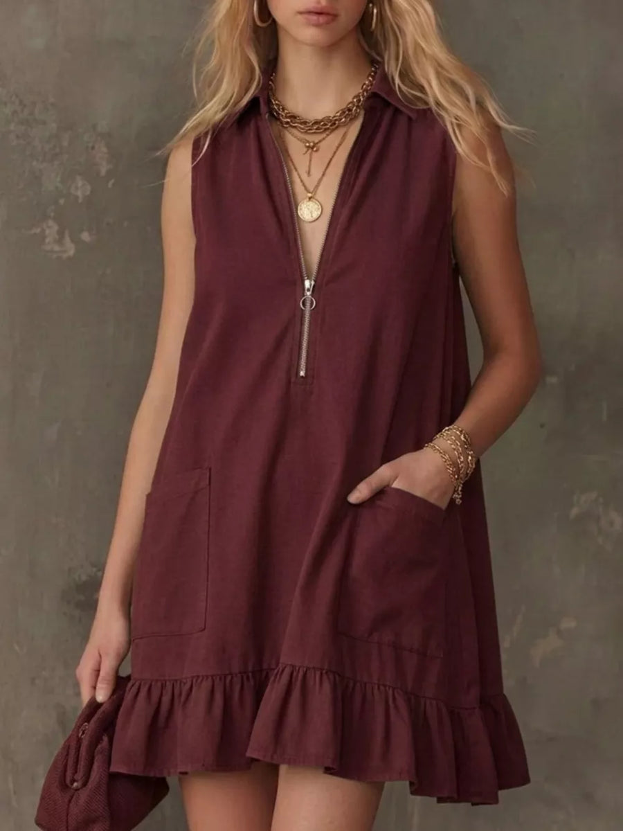 Burgundy zip-front collared dress with ruffle hem and pockets.