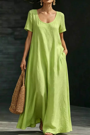 Lime green polyester maxi dress with short sleeves and pockets, a-line cut.