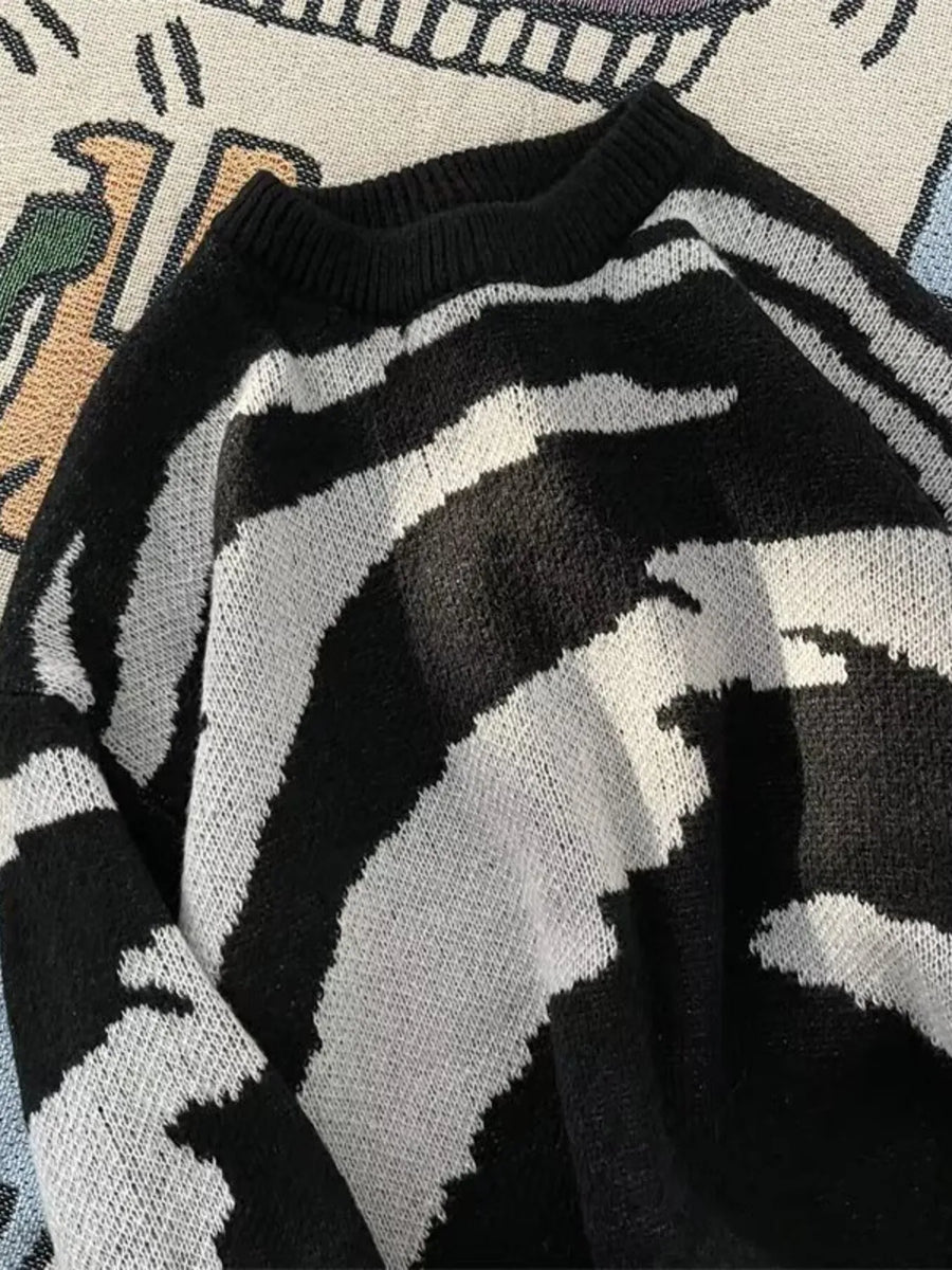 Men's black and white abstract print round-neck sweater with a knit texture.