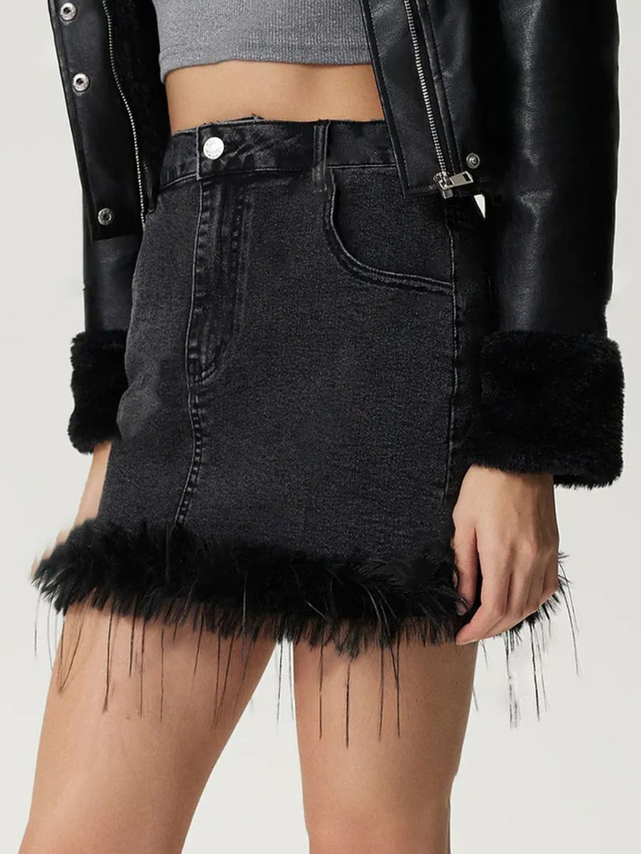 Black denim mini skirt with feather trim hem and cuffs.