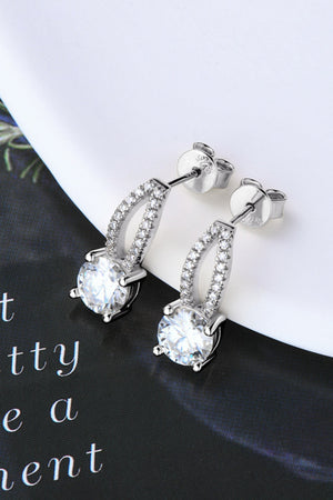 Silver stud earrings with a dangling design featuring a large round moissanite stone and a pave-set crystal accent.