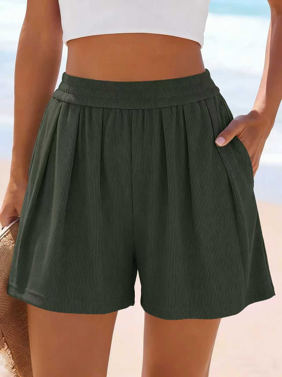 Dark green ribbed shorts with elastic waist and pockets