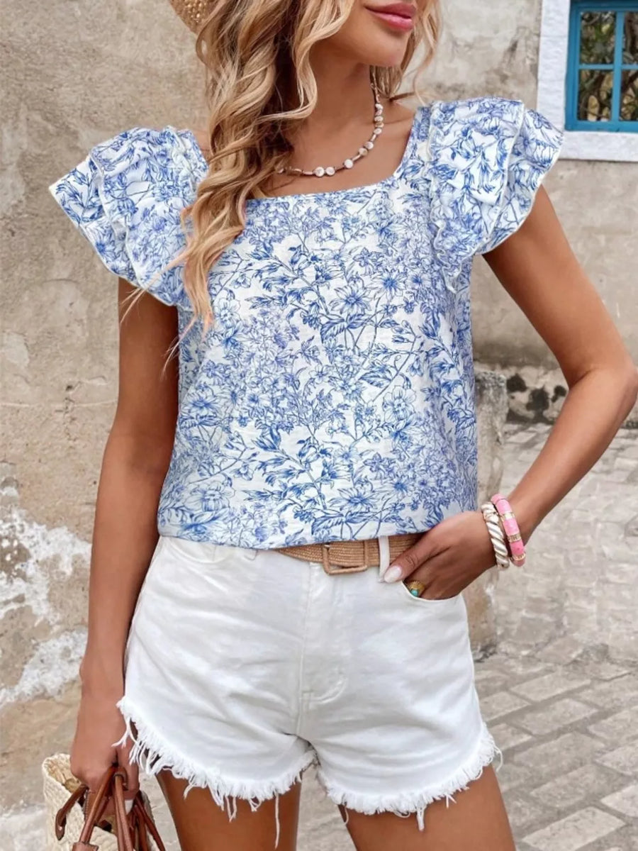Blue floral ruffle blouse with square neckline and short sleeves.