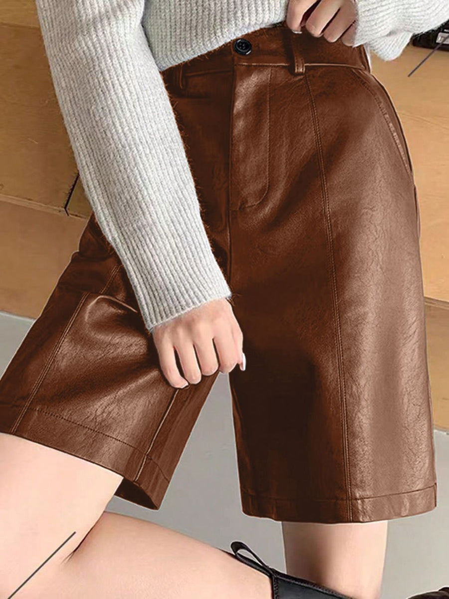 Brown vegan leather bermuda shorts with button closure and tailored fit.